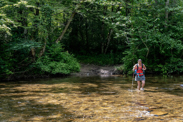 Woman Wades Through Wide Creek