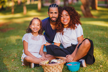 Happy family doing picnic in the park