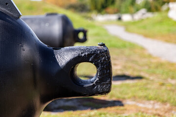 Rear of a black fire cannon closeup - obrazy, fototapety, plakaty