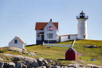 Fototapeta na wymiar Lighthouse in Maine with American Flag