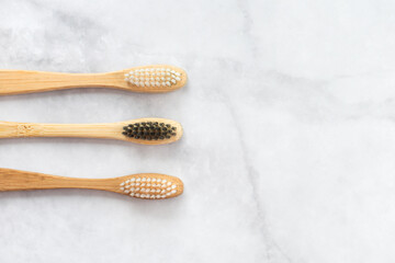 Two bamboo toothbrushes on marble background. Dental and healthcare concept. Top view, flat lay. Free copy space. - 416192322