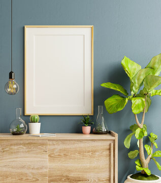 Mockup frame on cabinet in living room interior on empty dark blue wall background.
