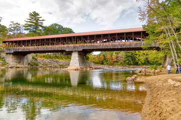 Fototapeta premium Soft reflection of a covered bridge over a river