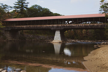 covered bridge over a calm river