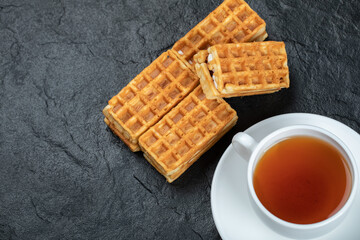 A cup of aroma tea with delicious waffles