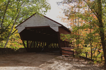 Covered bridge surrounded by autumn trees
