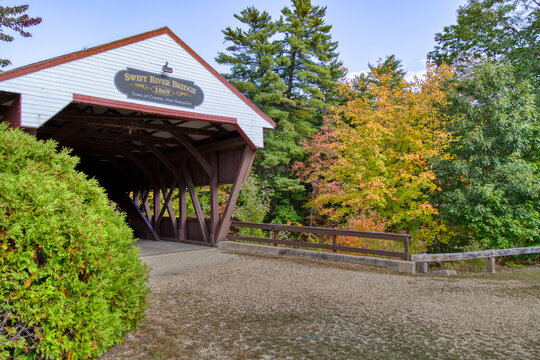 Covered bridge with red roof in autumn