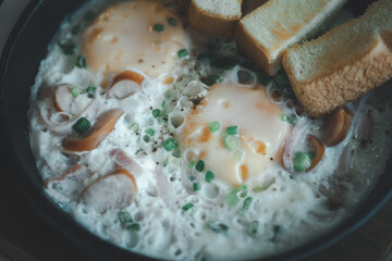 Pan fried egg with toppings and toast.