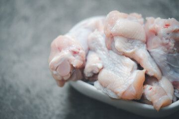 Fresh chicken legs or chicken drumstick ingredients for cooking in white bowl.
