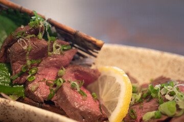 Slice of wagyu beef steak sprinkled with onion