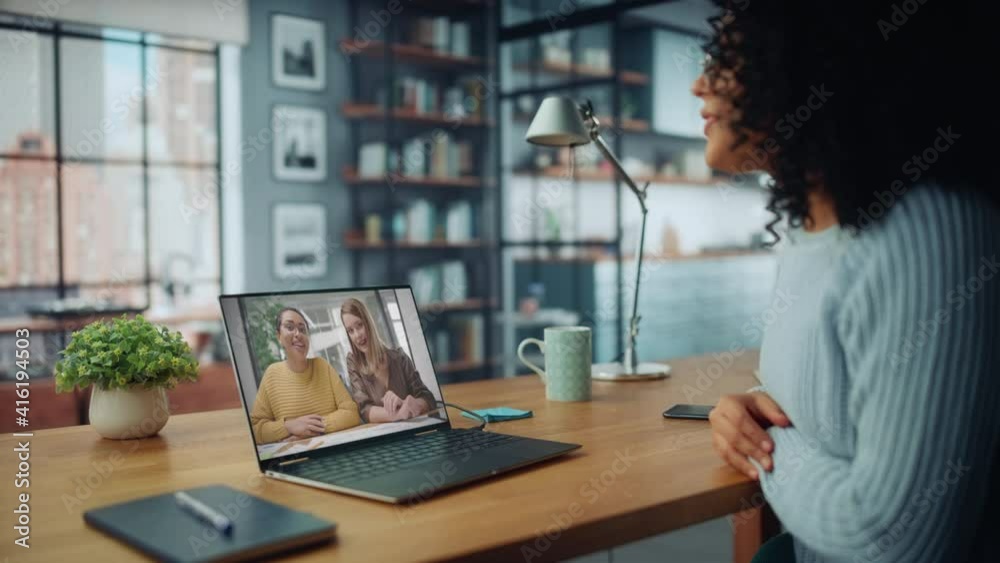 Aufkleber beautiful female specialist making a video call on laptop computer at home living room while sitting