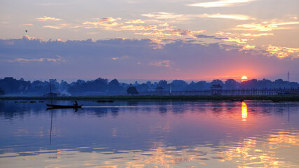 Fototapeta na wymiar Local fishermen in Taung Tha Man lake near U Bein bridge in early morning at sunrise. Mandalay, Myanmar (Burma).