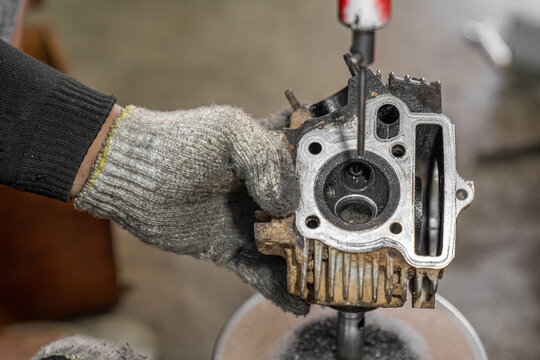 Grinding the motorcycle valve seat. Photo with noise