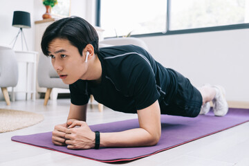 Young Asian man exercising at home
