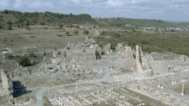 Drone video of an old ancient place. Historical ruins of the ancient city with ruins on the site of archeological excavations. Aerial view Antalya Turkey.