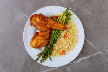Fried chicken drumsticks with spicy sauce on white background.