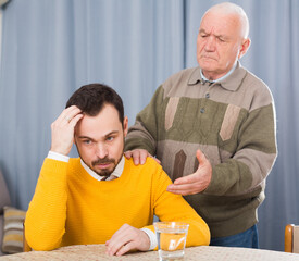 Aged father and son are serious talk and solve family problems