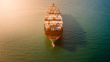 Fototapeta na wymiar container ship sailing on the sea and over the sun light