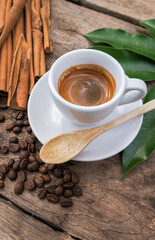 Close up of coffee background. coffee beans, ground coffee an espresso shot and Cinnamon Stick on dark concrete background. 