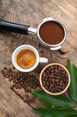 Close up of coffee background. coffee beans, ground coffee an espresso shot and Cinnamon Stick on dark concrete background. 