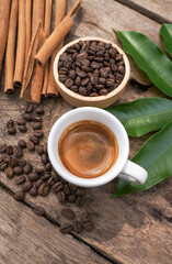 Close up of coffee background. coffee beans, ground coffee an espresso shot and Cinnamon Stick on dark concrete background. 