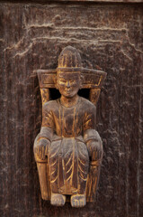 Wooden figure deity carving of Teakwood temple of Mandalay or Shwenandaw Monastery or Golden Palace Monastery for burmese people and foreign travelers travel visit in Mandalay of Myanmar or Burma