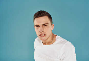 portrait of emotional man on blue background cropped view Copy Spac