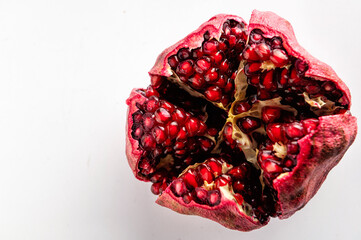 red ripe cut pomegranate on a white background, close-up top view