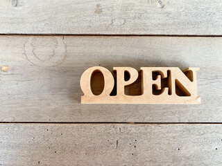 Text on wooden open sign,wooden sign with text open, entrance is available. Wood background