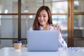 A beautiful businesswoman using laptop computer for working online and video conference