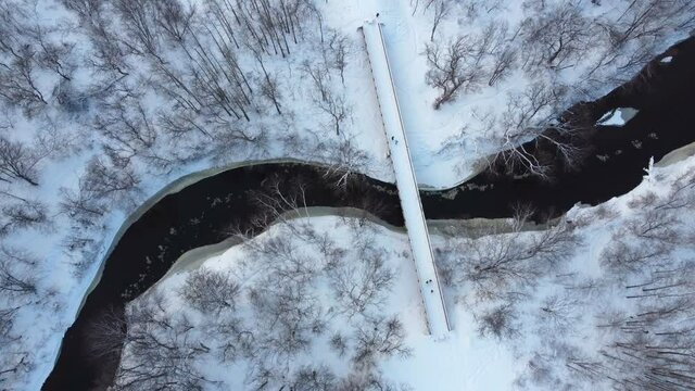People walking on a brige in winter.