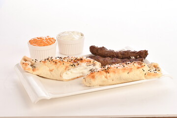 Arabic Traditional Ramadan , Kebab Roll Wrap , salad and hot pepper pickles on on a white background.