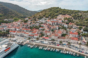 Fototapeta na wymiar Aerial drone shot of cruise ferry at Adriatic sea port on Vis Island in Croatia summer