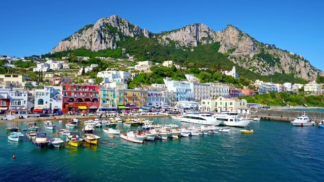 The green mountains and tourists on the coast of Capri, Italy