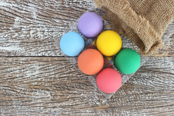 Easter eggs on wooden background with space