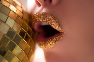 Golden lips. Seductive fashion. Beautiful makeup. Gold metal lip.