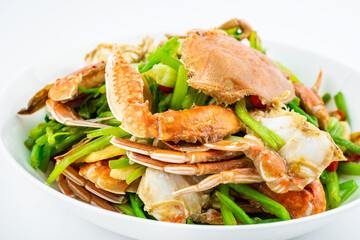 Fried flat crab with celery on a plate on white background