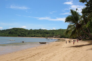 Children running on a beach on the island of Nosy Be, Madagascar.