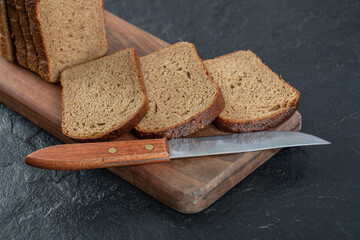 Slices of brown bread on a wooden board