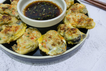Korean food Oyster Pancake with Soy sauce.