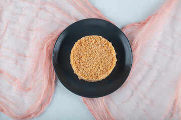 Delicious bulgur pilaf on a dark plate with cloth