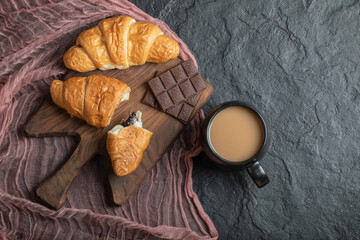 Croissants with chocolate filling on a wooden board