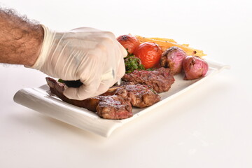 grilled beef steaks with spices isolated on white background
