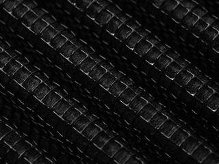 black and white industrial abstract background by closeup texture of car airconditioner purifier filter a shiny diagonal cured shape surface of metal grid frame with micro fiber filter inside