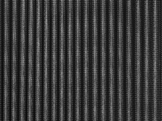 black and white industrial abstract background by closeup texture of car airconditioner purifier filter a shiny vertical cured shape surface of metal grid frame with micro fiber filter inside