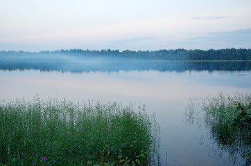 The nature of Seliger. Evening landscape with fog on Lake Glubokoe in the Tver region, Russia