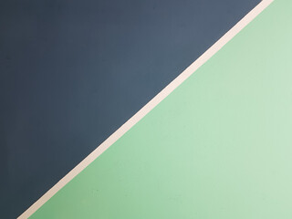 Painted wall in two colors dark blue and mint with a white stripe in the middle