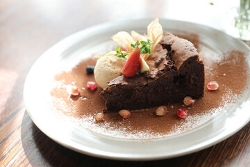 Fototapeta na wymiar Chocolate cake with ice cream dessert on wood table