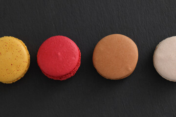 Colorful macarons isolated in black background