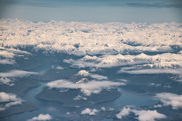 aerial view of clouds and snow cap mountains and lakes